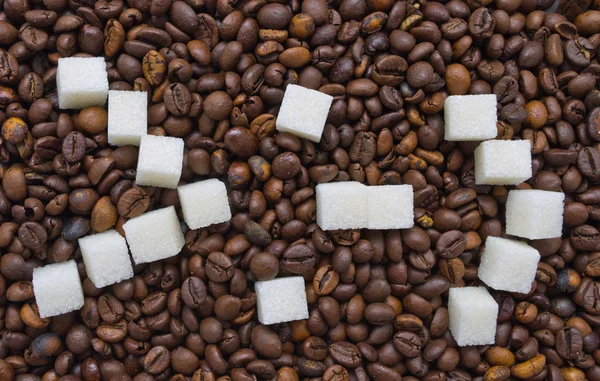 Funny composition of sugar in the form of a emoticon on the background of coffee beans Stock Picture