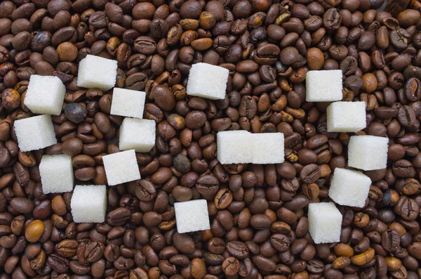 Funny composition of sugar in the form of a emoticon on the background of coffee beans Stock Image