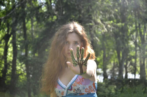 Girl with a painted tree on her hand. — Stock Photo, Image