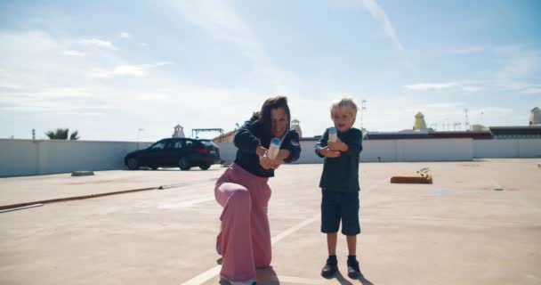 Jonge moeder met zoon hebben plezier exploderen rotje confetti — Stockvideo