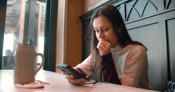 Joven mujer en restaurante viendo menú en línea con el código QR de la elección de alimentos — Vídeo de stock