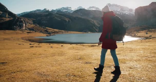 Female solo traveler hike on mountains with backpack — Video