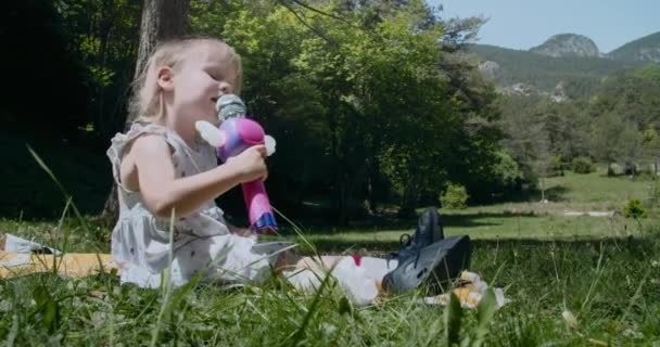 Mutlu küçük kız seğiriyor ve oyuncak mikrofonda şarkı söylüyor. — Stok video