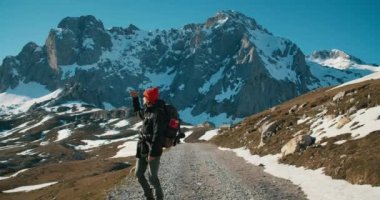 Tek başına gezen gezgin boş dağ yolunda yürüyor destansı doğa manzarasının tadını çıkarıyor. İlham veren adam yeni bir seyahat yeri keşfetti. Aktif ve sağlıklı yaşam tarzı ve yolculuk tutkusu