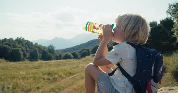 Child Sit Rock Beautiful Mountain Landscape Taking Break Drink Cold — ストック動画