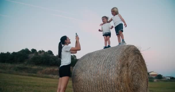 Happy Caucasian Family Field Haystack Mother Takes Photo Mobile Phone — Stockvideo