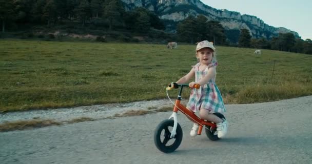 Happy Carefree Toddler Girl Cycling Balance Bike Empty Mountain Road — Video Stock