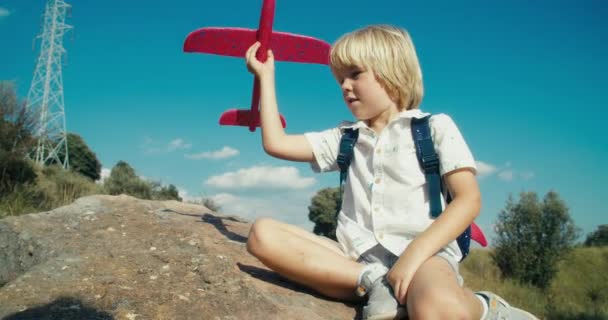 Child Summertime Sitting Rock Playing Toy Airplane Travel Concept Carefree — Stockvideo