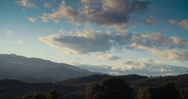 Beautiful sky at sunset on mountain landscape in timelapse. Concept of weather and earth exploration. Movement of the clouds on blue sky at evening. 