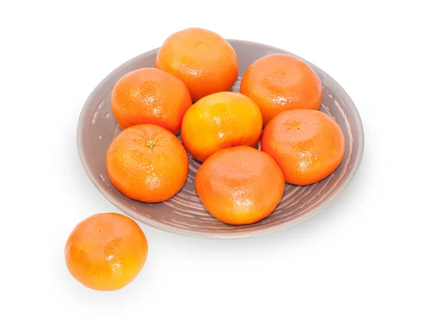 Several mandarins on brown plate Stock Photo