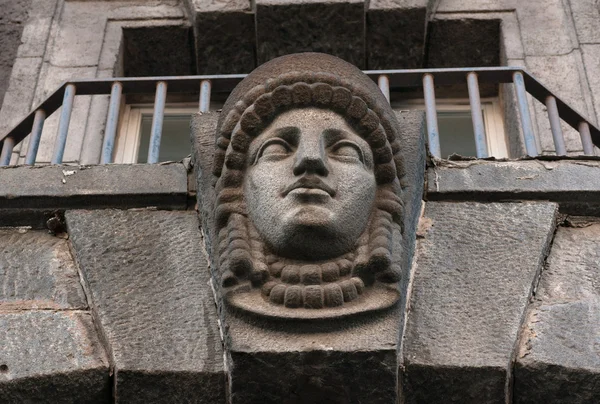 Decorative feature ancient building in the form of a female head — Stock Photo, Image