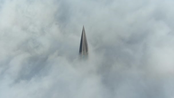 Rusia, San Petersburgo, 14 de octubre de 2021: La cima del rascacielos más alto de Europa por encima de las nubes, el edificio de la compañía petrolera Gazprom, la aguja de una estructura de metal y vidrio — Vídeo de stock