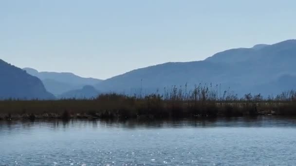 De pittoreske baai van Ekinchik in Turkije, vlakbij een van de vele eilanden in de buurt van Fethye, vissersboten, bergen op de achtergrond — Stockvideo