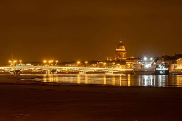 Nagranie panoramiczne zimowej nocy miasta Sankt-Petersburg z malowniczą refleksją na temat wody, duży statek zacumowany w pobliżu mostu Blagoveshchensky lub porucznik Schmidt, katedra Isaac na tle — Zdjęcie stockowe