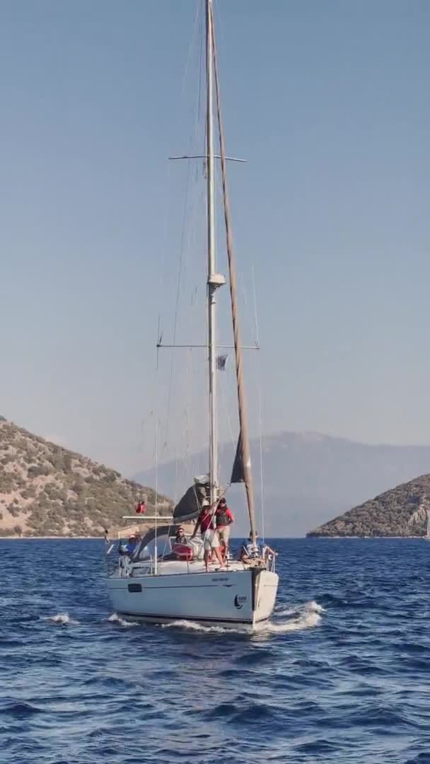 Turquie, Fethiye, 03 Octobre 2021 : La baie pittoresque de Sarsala, près de l'une des nombreuses îles près de Marmaris, les participants de la régate de voile sur le bateau, montagnes sur fond — Video