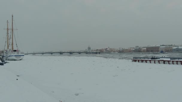 Rússia, São Petersburgo, 07 de dezembro de 2021: imagens em câmera lenta da vista de inverno de São Petersburgo na tempestade de neve, rio Neva congelado, vapor sobre a cidade, catedral Isaac, tráfego de carros na ponte Blagoveshenskiy — Vídeo de Stock