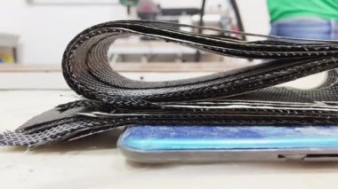 Carbon sheets lie on a scale for weight control in the workshop for the production of carbon products