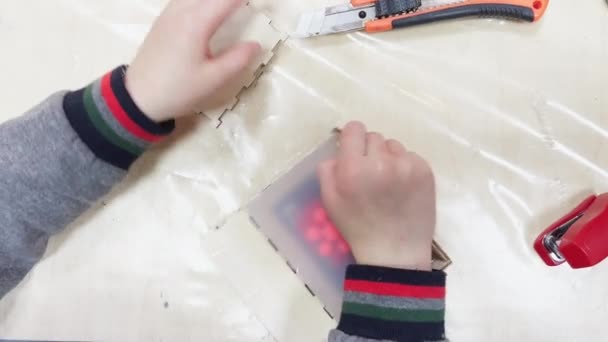 Childrens hands disassemble the mold of rubber, the matrix for making plastic products, construction tools are on the table — Vídeo de Stock