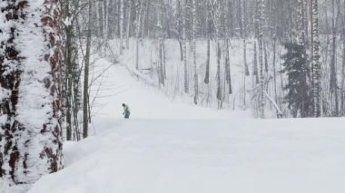 Russia, St. Petersburg, 03 January 2022: Young people on skis and snowboards on the slopes of the ski resort on the weekend, colorful overalls of athletes on a snowy winter day