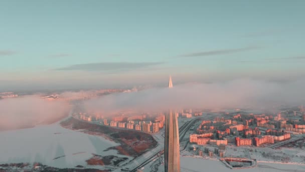 Russia, St. Petersburg, 08 January 2022: Lakhta center skyscraper in a winter frosty evening at sunset, the future main building of the office of the oil company Gazprom, buildings of pink color — Stockvideo