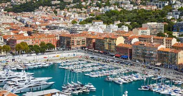 A lot o motor boats and luxury yachts are moored in port of Nice - France at sunny day, mooring ropes go into the amazing azure water, prows of motor boats in a row, roofs of orange color — Stock Photo, Image