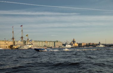 Güneşli bir günde Rus Donanması 'nın bayramından önce Neva Nehri' ndeki savaş gemilerinin bulunduğu manzara, tarihi noktalar arasındaki en son kruvazörler, Saray Köprüsü.
