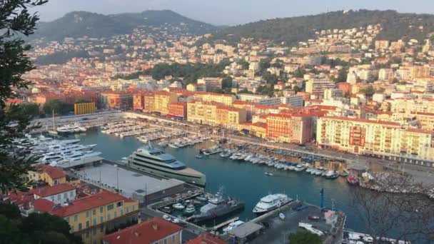 A lot o motor boats and luxury meg yachts are moored in port of Nice - France at sunset, mooring ropes go into the amazing azure water, prows of motor boats in a row, roofs of orange color — Stock Video