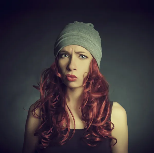 The girl with red hair in a sports cap — Stock Photo, Image