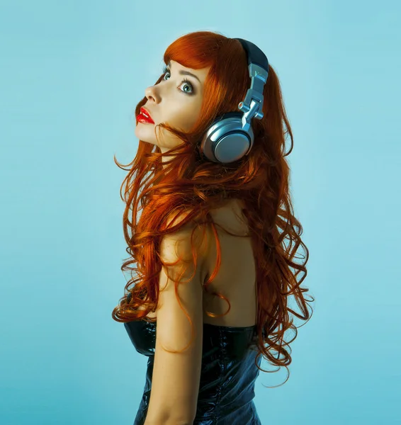 Redhead girl with headphones — Stock Photo, Image