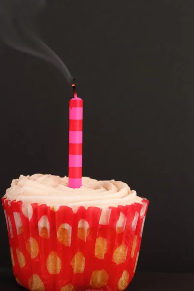 Cupcake with blown out candle — Stockfoto