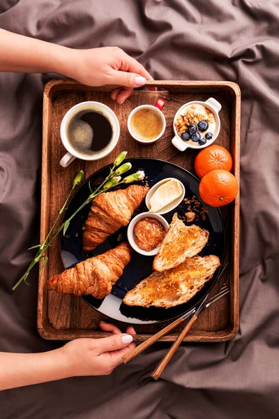 Woman Serving Continental Breakfast Rustic Wooden Tray Bed Grey Sheets — Stock Photo, Image