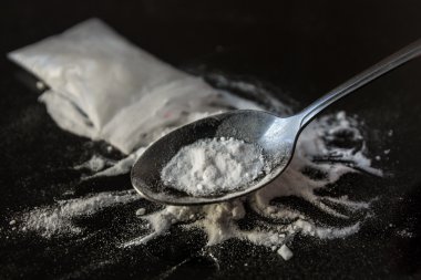Heroin being cooked in a spoon clipart