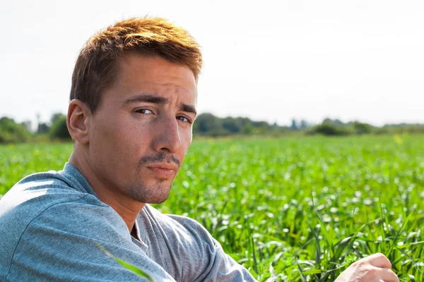 Retrato de um jovem bonito em um parque — Fotografia de Stock