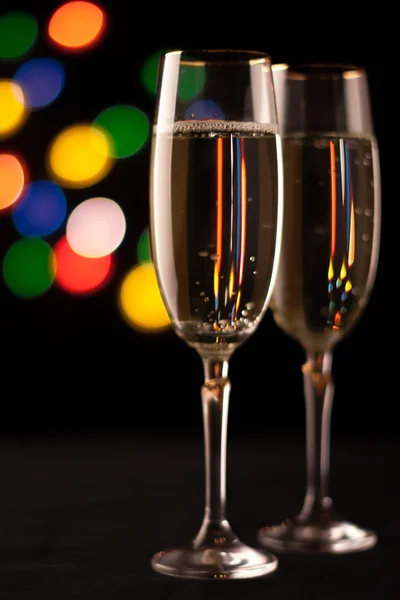 Två glas champagne rostningen mot bokeh ljus bakgrund — Stockfoto