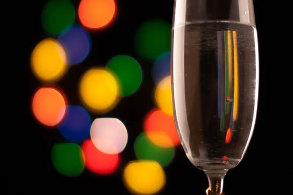 Two glasses of champagne toasting against bokeh lights background — Stock Photo, Image