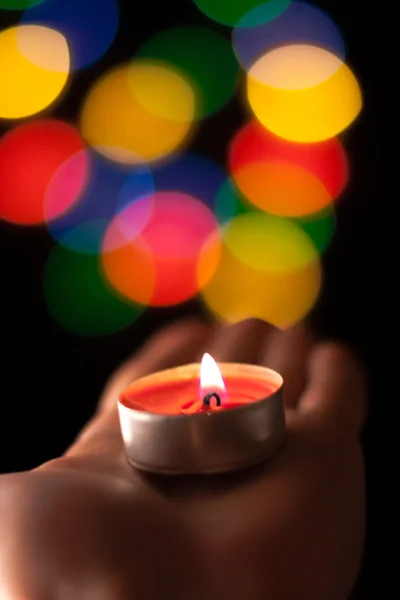 One candle on hand in atmospheric light — Stock Photo, Image