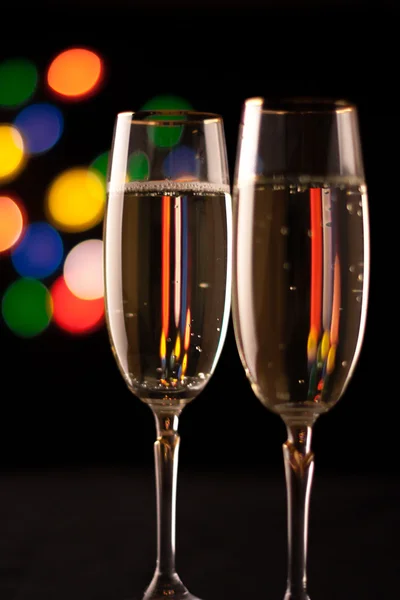 Två glas champagne rostningen mot bokeh ljus bakgrund — Stockfoto