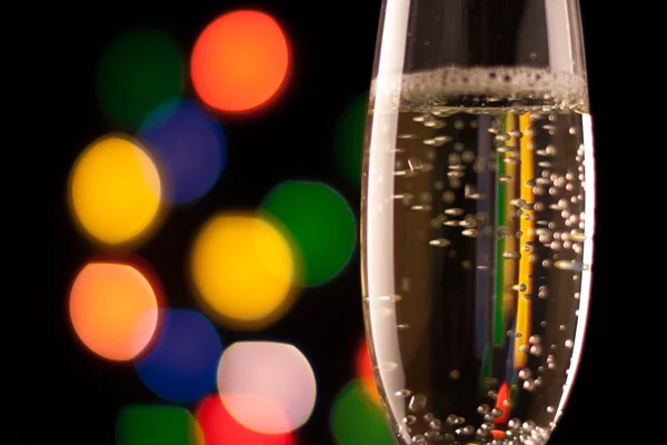 Two glasses of champagne toasting against bokeh lights background — Stock Photo, Image