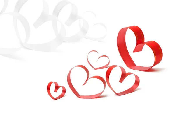 Herzförmige Bänder auf weißem Valentinstag-Konzept — Stockfoto