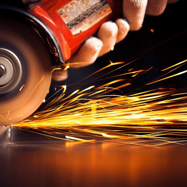 Metal sawing. Hot sparks at grinding steel material. Stock Photo by
