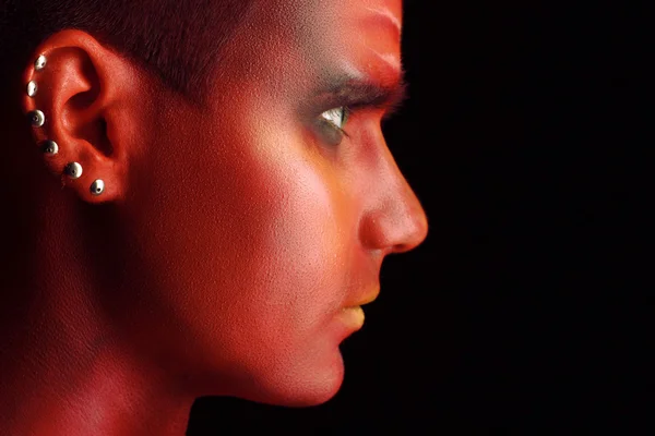 Portrait of a handsome young man in a red body painting — Stock Photo, Image