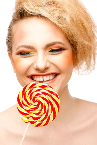 Woman licks candy with beautiful make-up isolated on white background — Stock Photo, Image