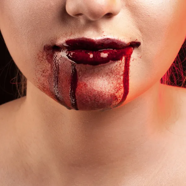 Closeup of Red lips of a young girl, with blood flowing by. — Stock Photo, Image