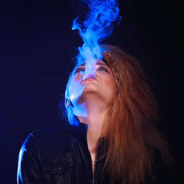 Woman with Cigarette Exhaling Smoke  on a Dark Background — Stock Photo, Image