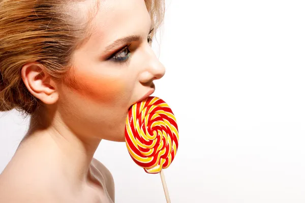 Woman licks candy — Stock Photo, Image