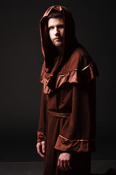 Mystery monk praying on kneels — Stock Photo, Image