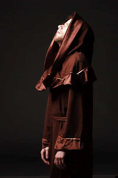 Mystery monk praying on kneels — Stock Photo, Image