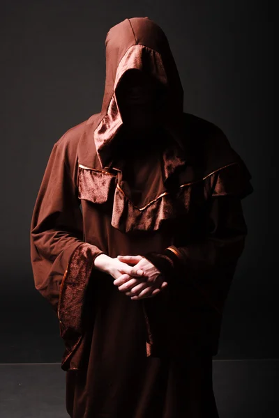 Mystery monk praying on kneels — Stock Photo, Image