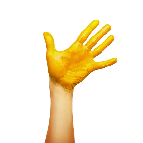 Рука в желтой краске — стоковое фото