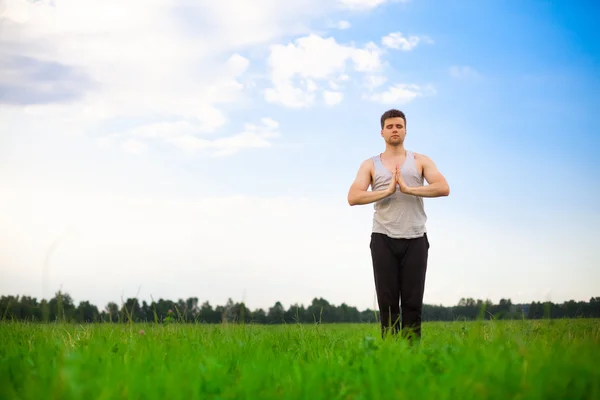 Jeune homme faisant du yoga dans le parc — Photo